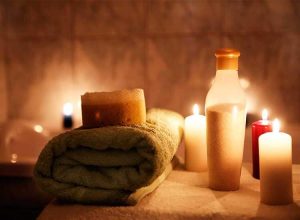 Beautiful spa image with burning candles and mssage towel - spa massages center